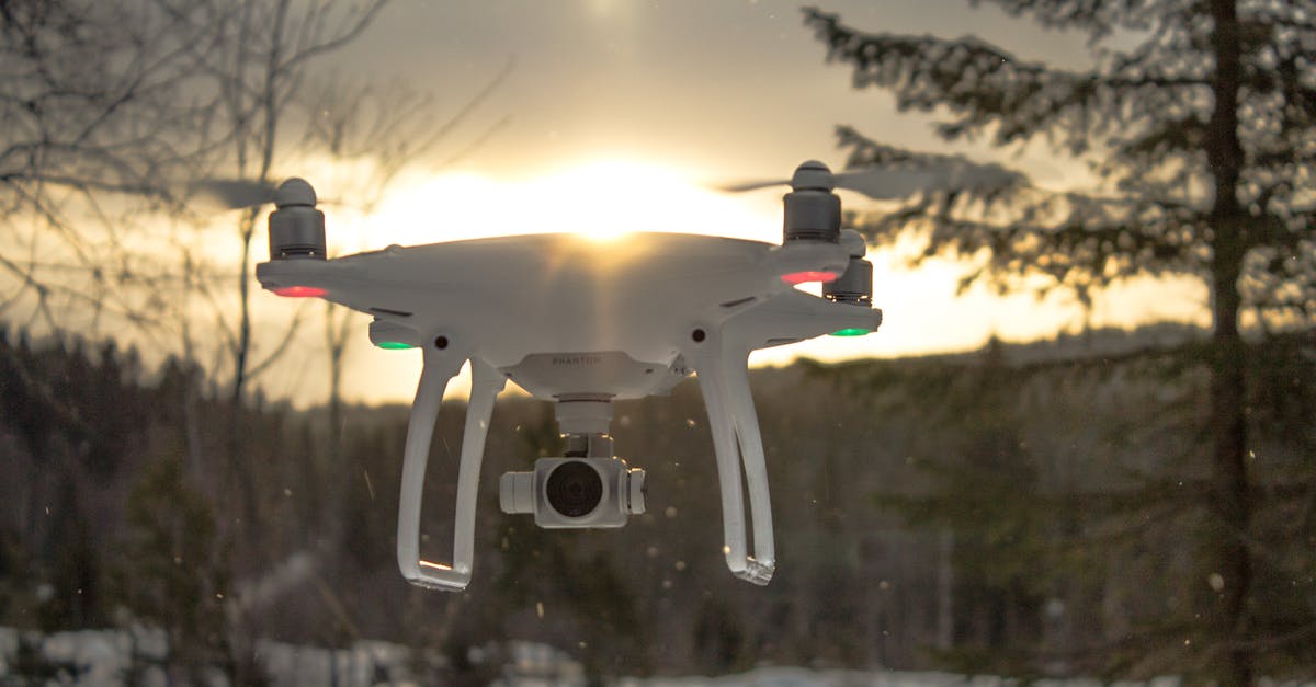 4 thermometers, 4 readings - Photo of White Drone Quadcopter Flying Near Trees at Noontime