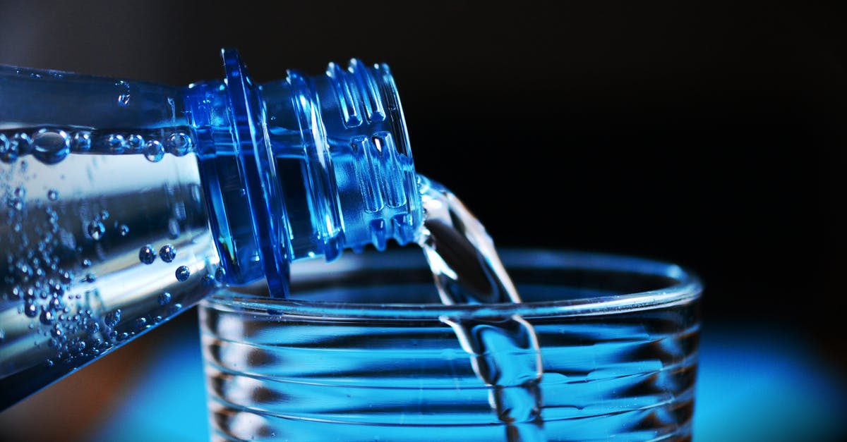 5 Gallon Drinking Water Container - Close-up of Bottle Pouring Water on Glass