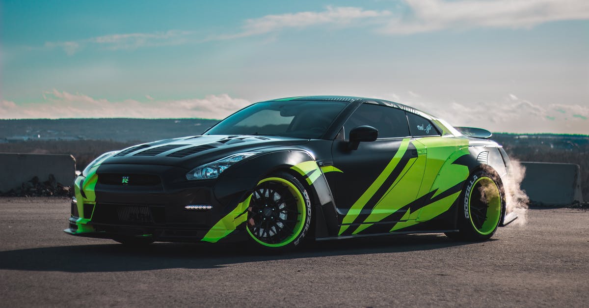 A good way to smoke Picanha? - Modern tuned sports car with tinted windows drifting on asphalt road against cloudy blue sky