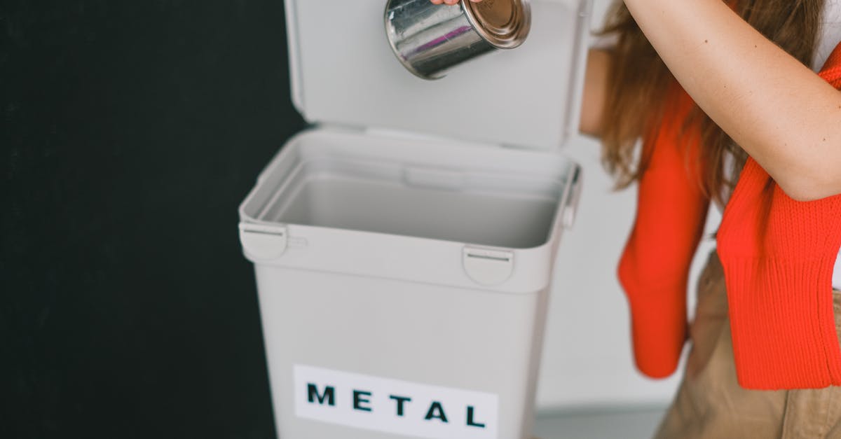 A salad chopper I can put in the dishwasher? - Woman sorting garbage and putting metal can into bucket