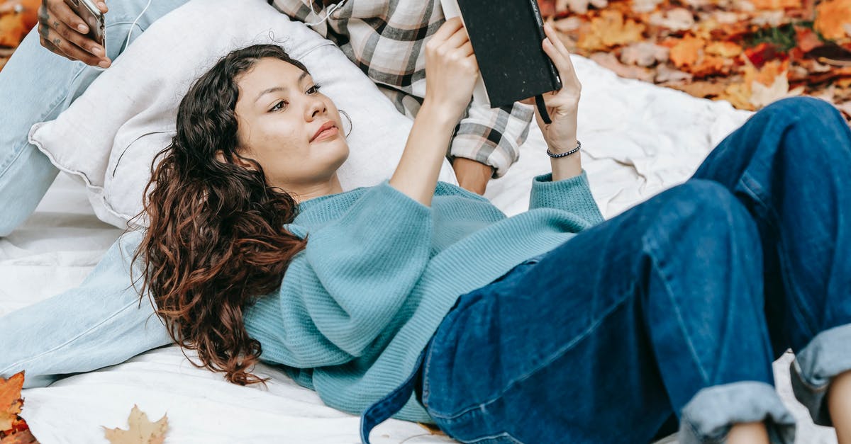 A steak story: dry crust - Focused Hispanic woman reading book in nature