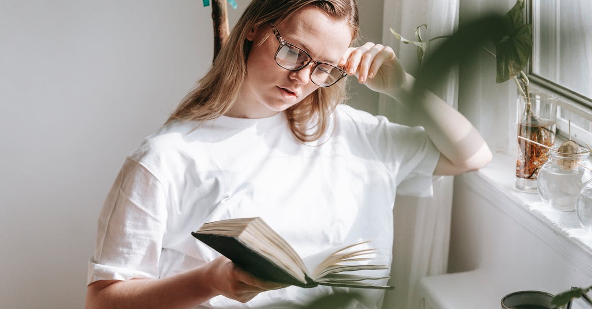 Absorb precipitates when heating water in a microwave? - Attentive woman in eyewear reading notebook at home