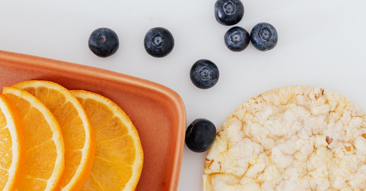 Adapting graham cracker crust to all-natural graham crackers - From above of fresh orange slices placed on cutting board near blueberries and rice cracker on white surface