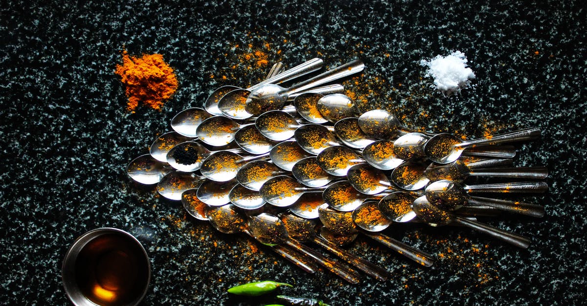 Add spice then oil, or oil then spice? - Steel spoons and spices in creative serving