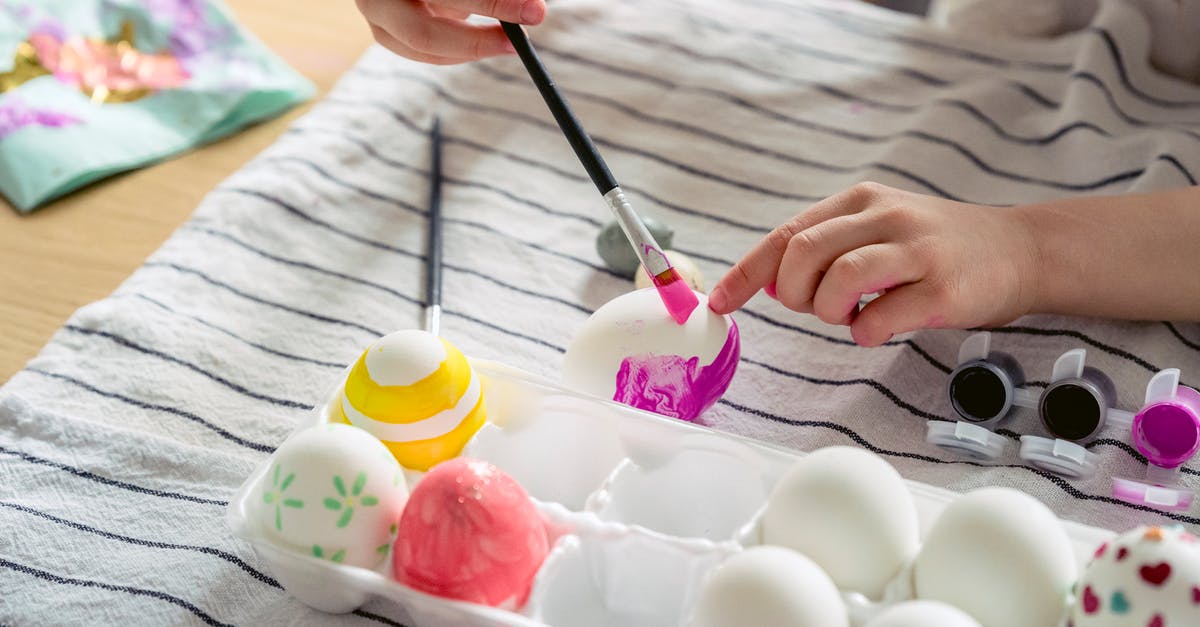 Adding eggs to lasagna - A Person Painting Eggs