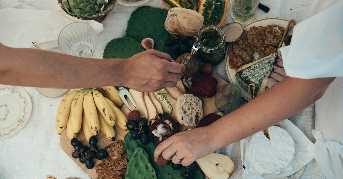 Adding fresh fruit to a non fruited banana bread - Couple having healthy picnic together in summer