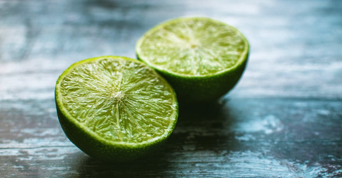 Adding lime juice to green curry paste and heating - Closeup Photography of Sliced Calamondin