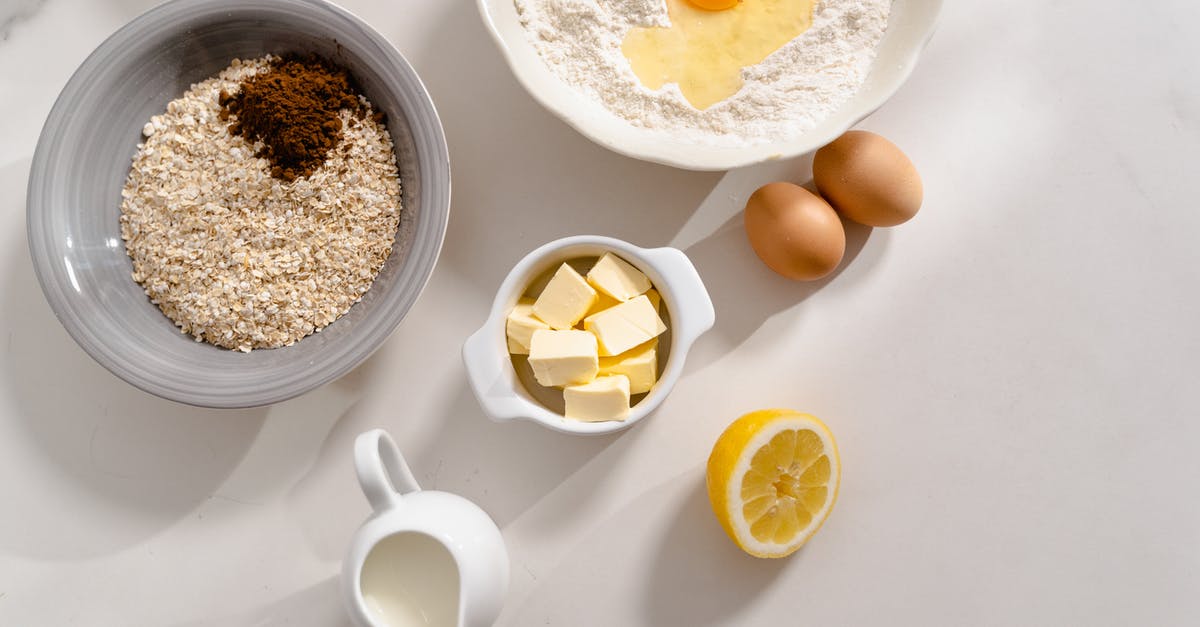 Adding melted butter to cold milk in baking - Recipe Ingredients on White Surface