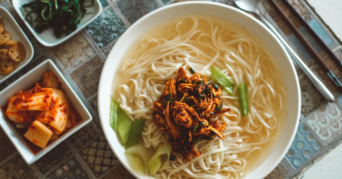 Adding Noodles to Soup - Noodle Dish on White Ceramic Bowl