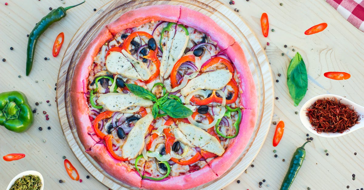 Adding tomatoes to pizza dough - A Colorful Sliced Pizza