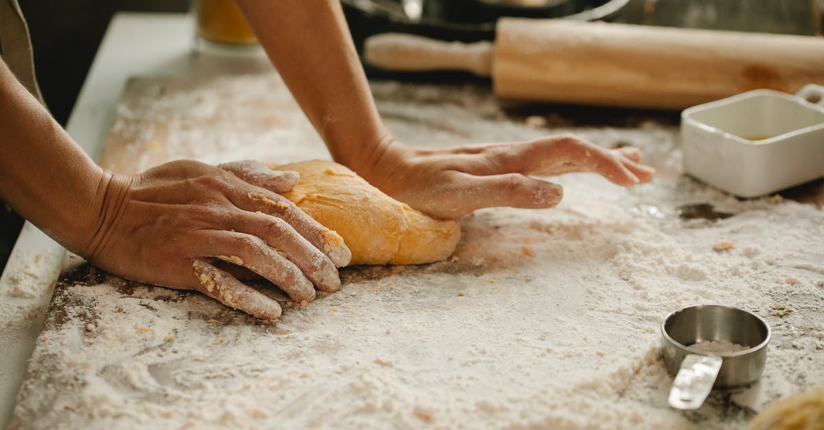 Adding too much flour to bread dough in Kitchenaid Stand Mixer? - Woman making pastry on table with flour