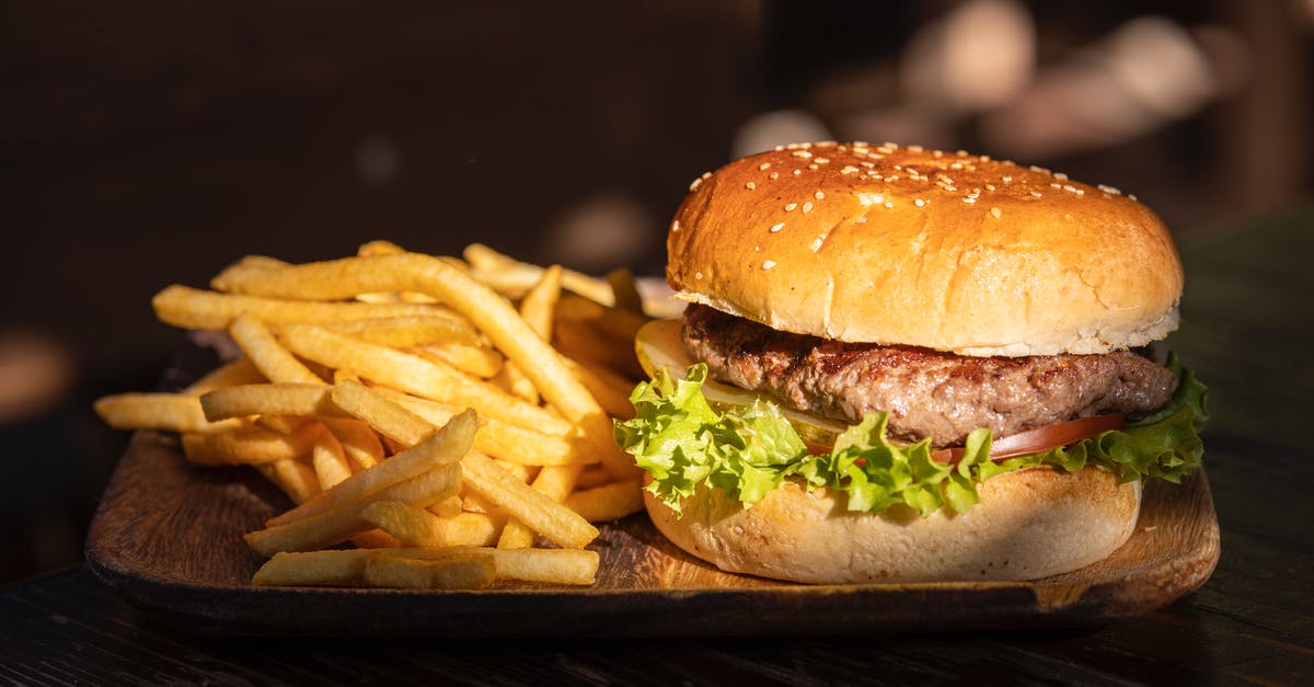 Adding water to a pan-fried burger - Plate of Fries and Burger