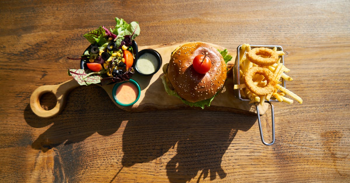 Adding water to a pan-fried burger - Burger on Brown Platter