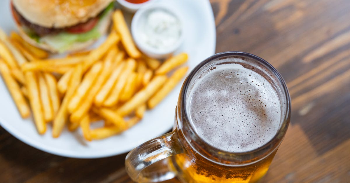 Adding water to a pan-fried burger - Clear Glass Mug With Brown Liquid