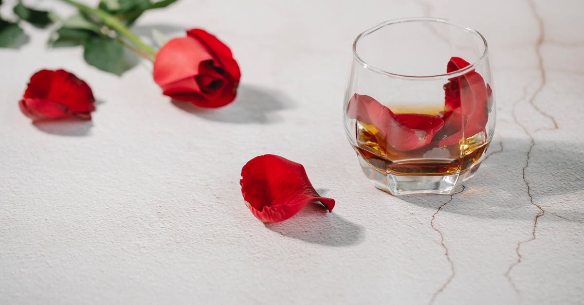 adjust flavor from inexpensive brandy - Red rose petals in glass of cognac