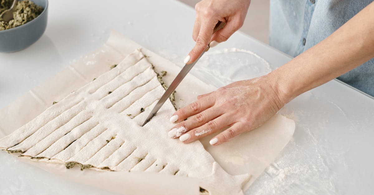 Adjusted cooking time for an already-baked pie shell - Person Slicing a Christmas Tree Shaped Bread With Fillings