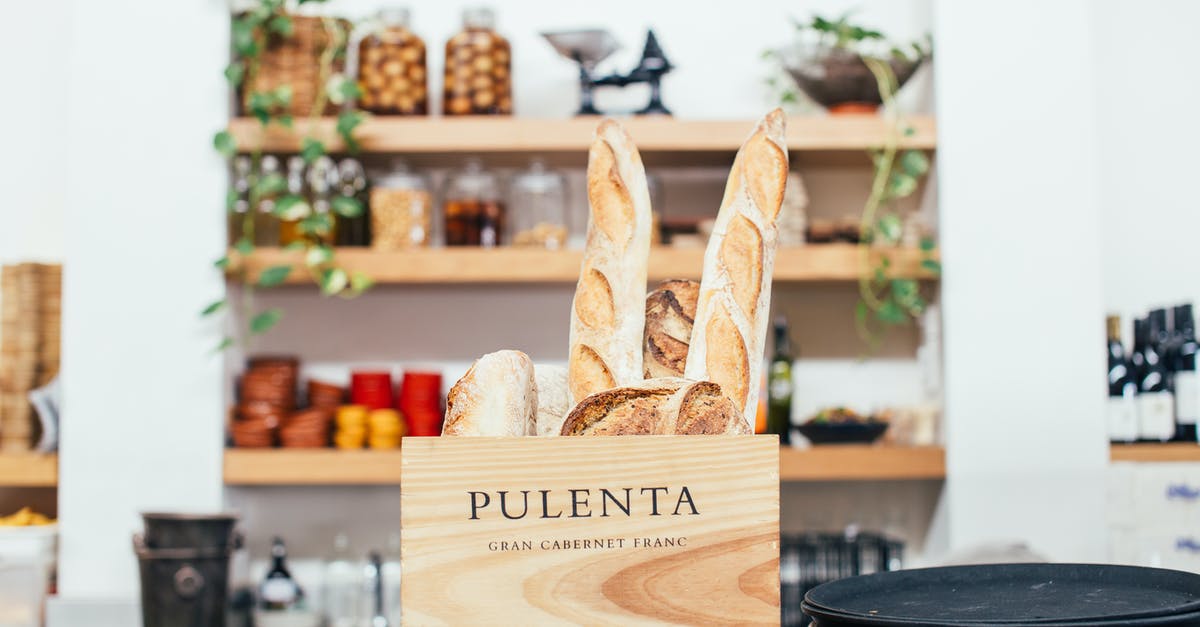 Adjusting Bread flavor - Tasty fragrant baguettes and bread placed in timber box on counter of modern cafe on blurred background