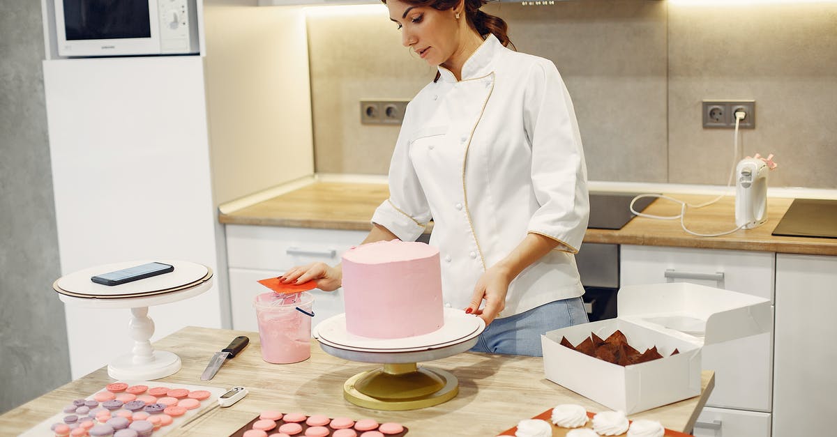 Adjusting dessert recipes to accomodate a larger slow cooker - Serious young woman in apron preparing desserts in modern confectionery