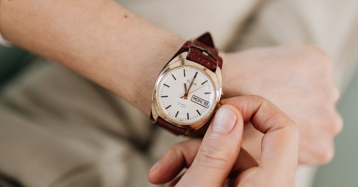 Adjusting Microwave Times - Person Adjusting His Watch