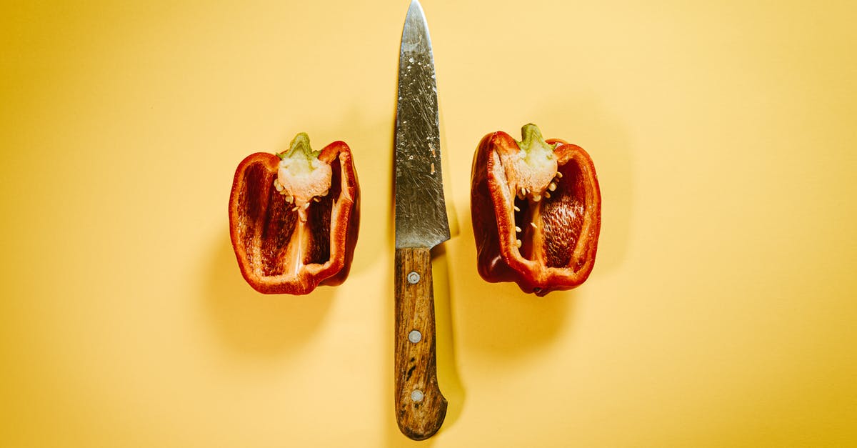 Age between mild and sharp - Cut red bell pepper with knife on surface