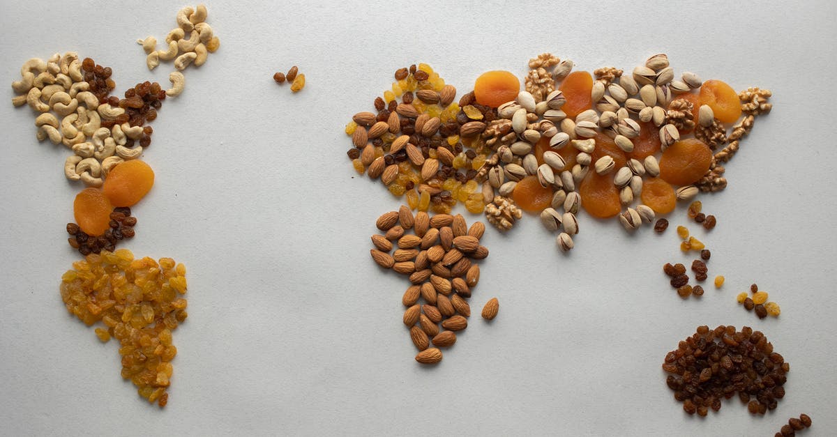 Almond extract: oil- or alcohol-based? - Top view of creative world continents made of various nuts and assorted dried fruits on white background in light room