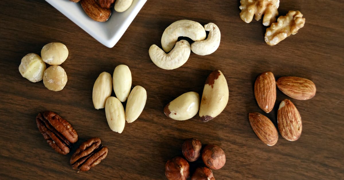 Almond milk: pasteurize almonds and water before sealing? - Variety of Brown Nuts on Brown Wooden Panel High-angle Photo