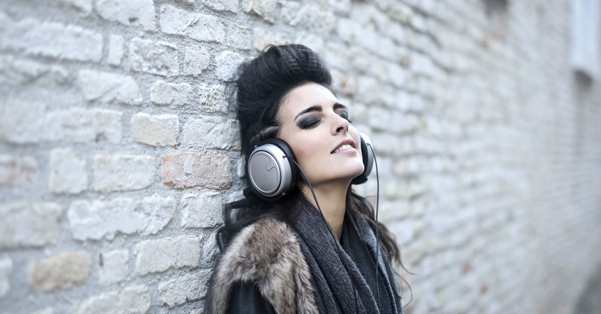 Alternative to Wisconsin Brick Cheese - Informal young woman listening to music near grunge wall