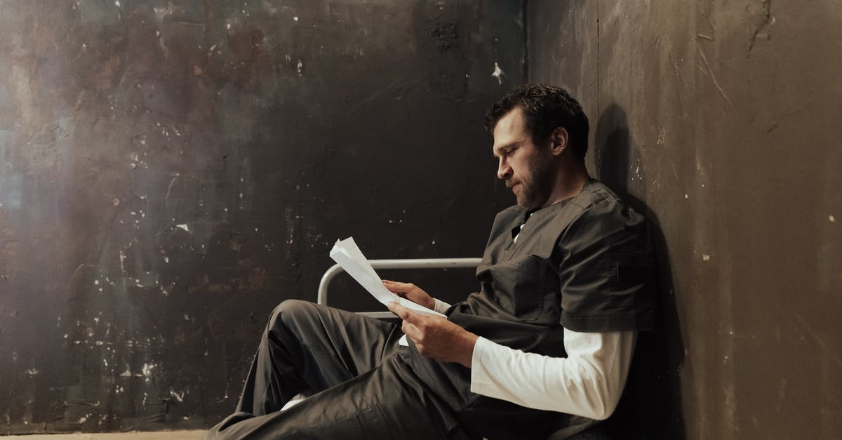 Aluminized Paper Wrapper Sides - Man in Black Jacket and White Pants Sitting on Chair