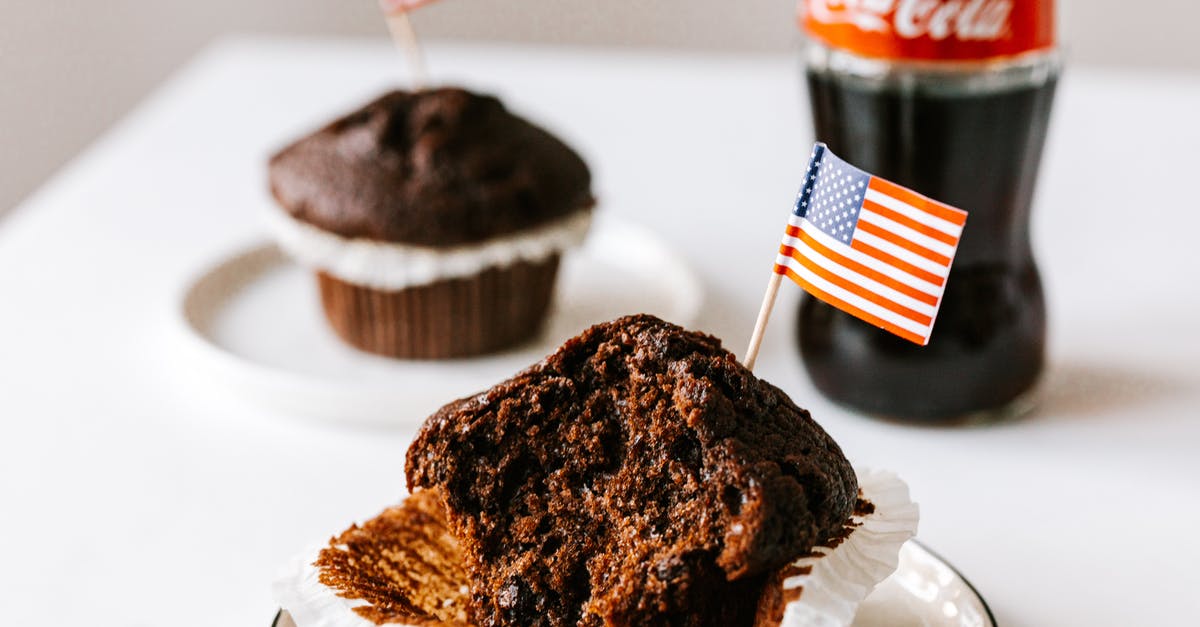 American equivalent for British chocolate terms - Sweet cakes with toothpick american flags placed on table with soda bottle