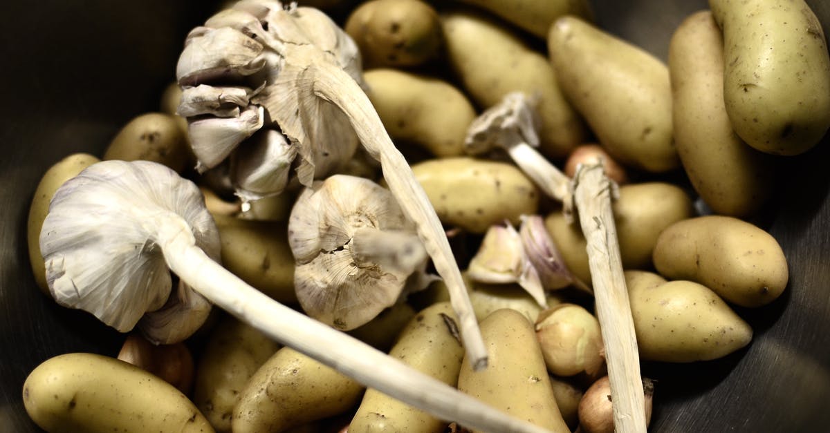 American Potatoes vs. Spanish Potatoes - Close-Up Shot of Potatoes and Garlic