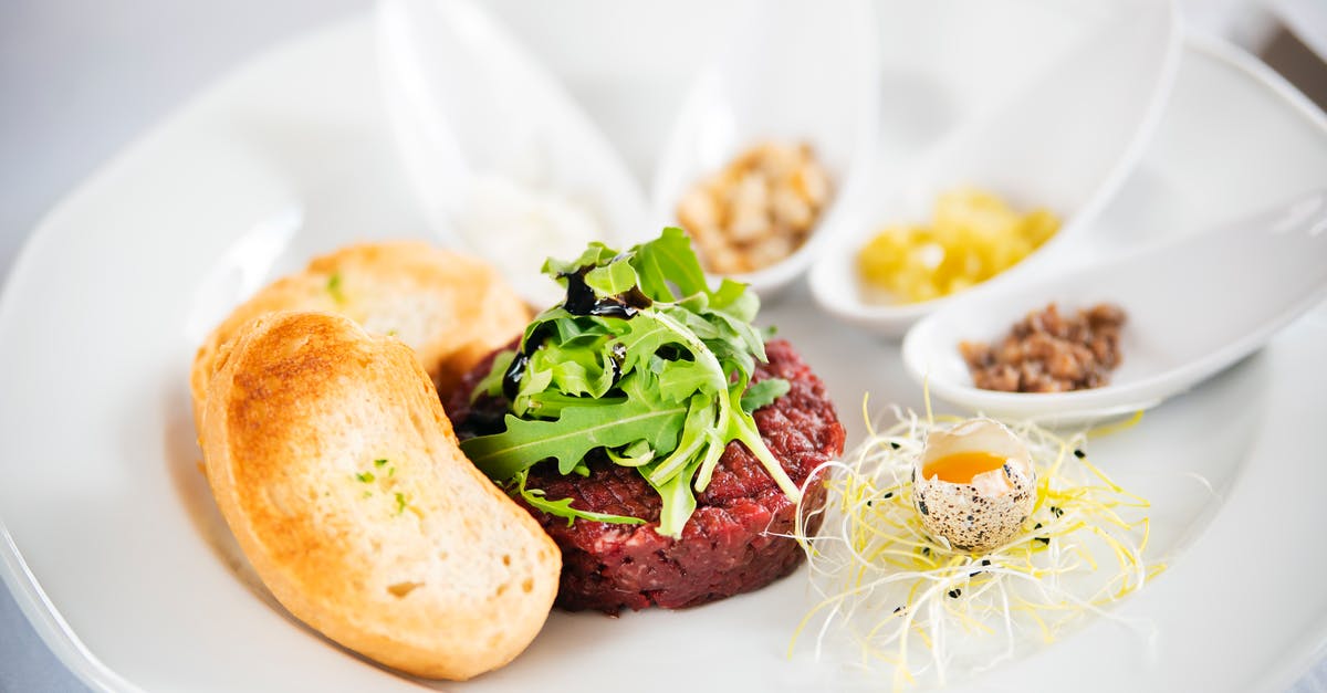 Amish Friendship Bread starter with buttermilk - Delicious steak tartare with arugula leaves on plate