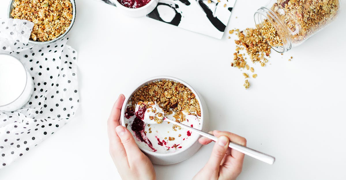 Anti-Coagulant for Oat Milk - Person Mixing Cereal, Milk, and Strawberry Jam on White Ceramic Bowl