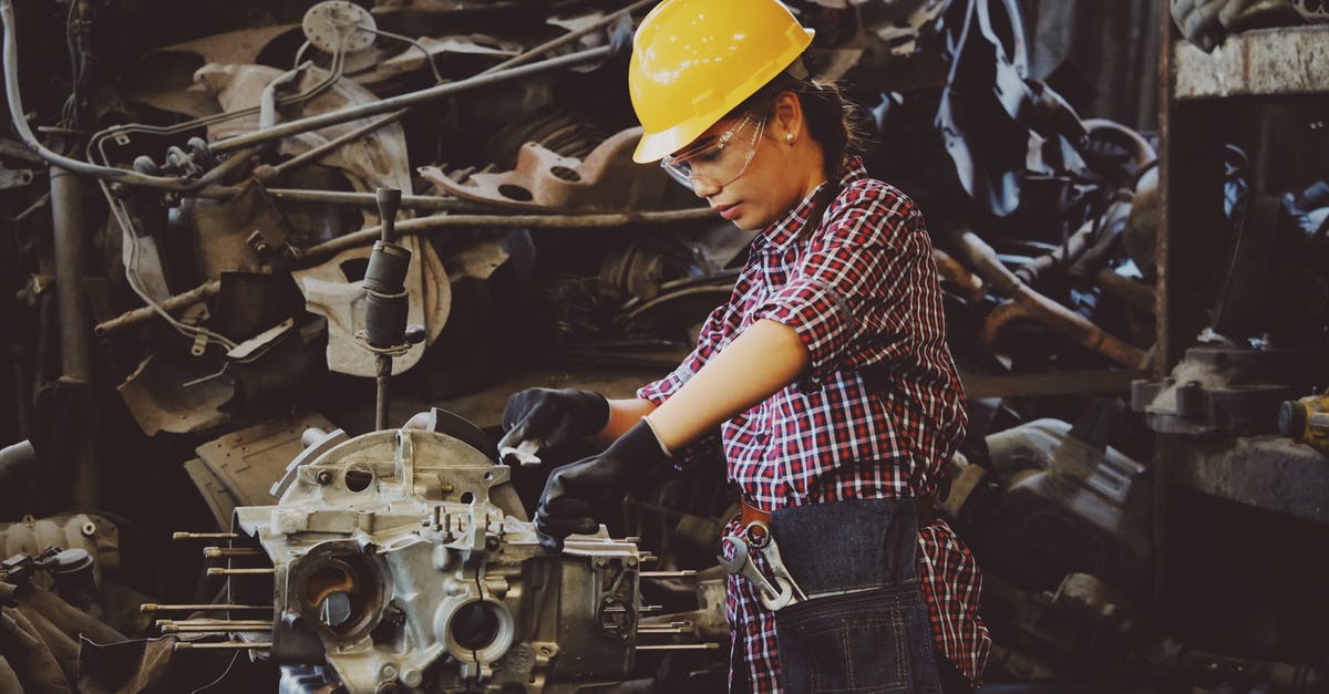 Any fix for a warped carbon steel fry pan? [duplicate] - Woman Wears Yellow Hard Hat Holding Vehicle Part