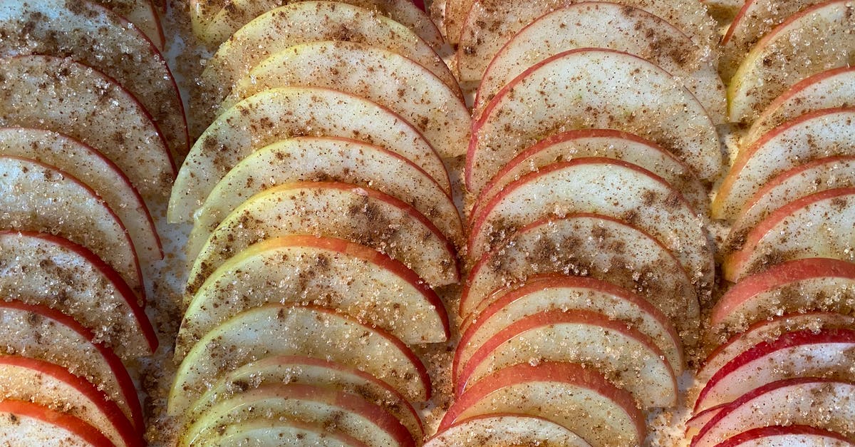 apple crumble for pie - Closeup of delicious homemade pie with rows of slices of apples covered with sugar and cinnamon