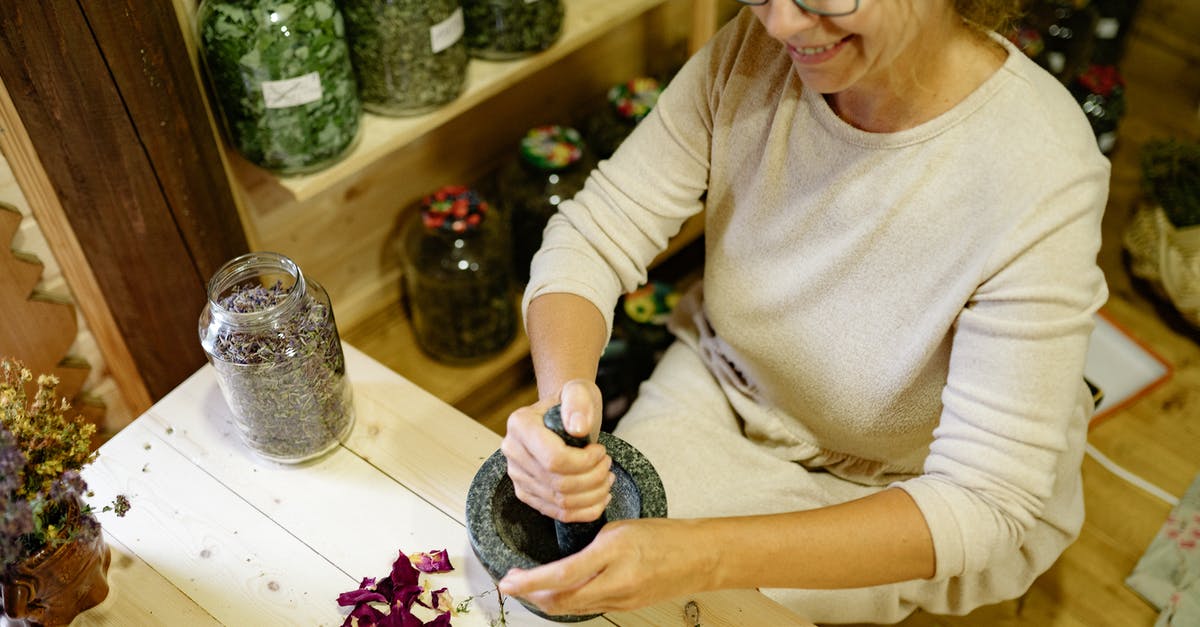 Are 'premium' spices worth the expense? - Woman in Beige Long Sleeve Shirt Holding Black and White Textile