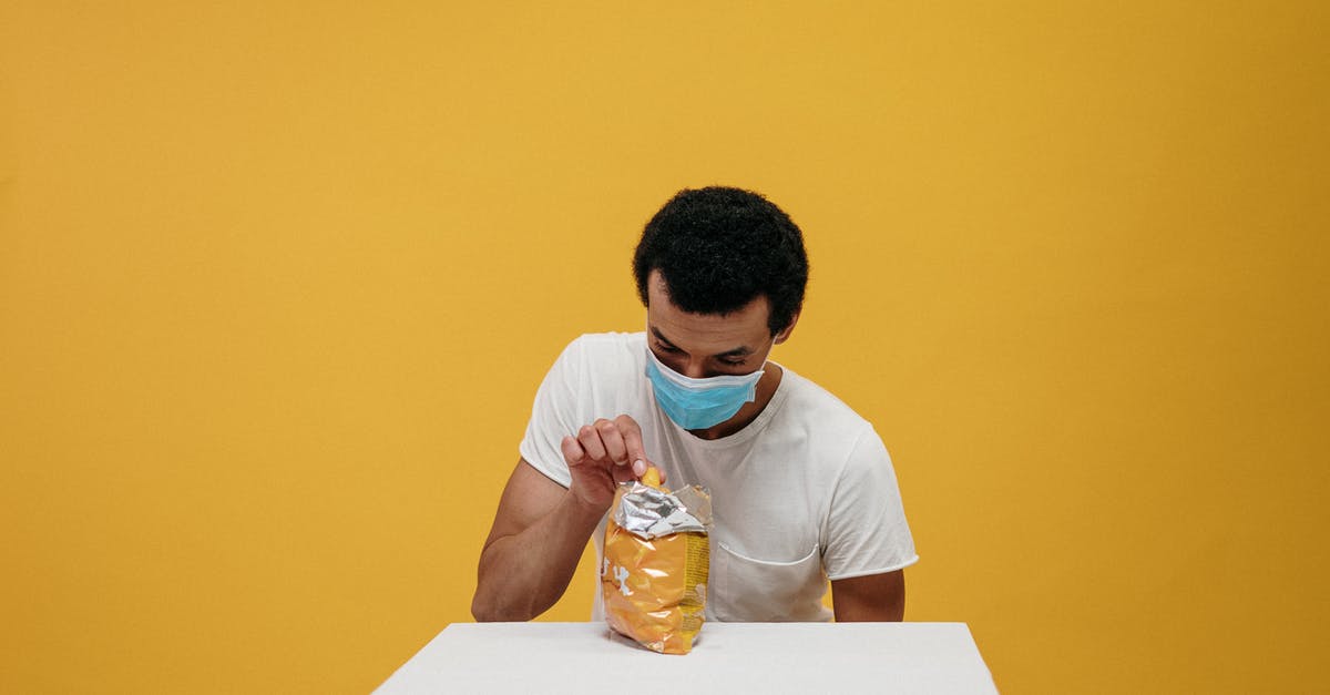 Are accidentally fermented foods safe to eat - Man in White Crew Neck T-shirt Eating Chips