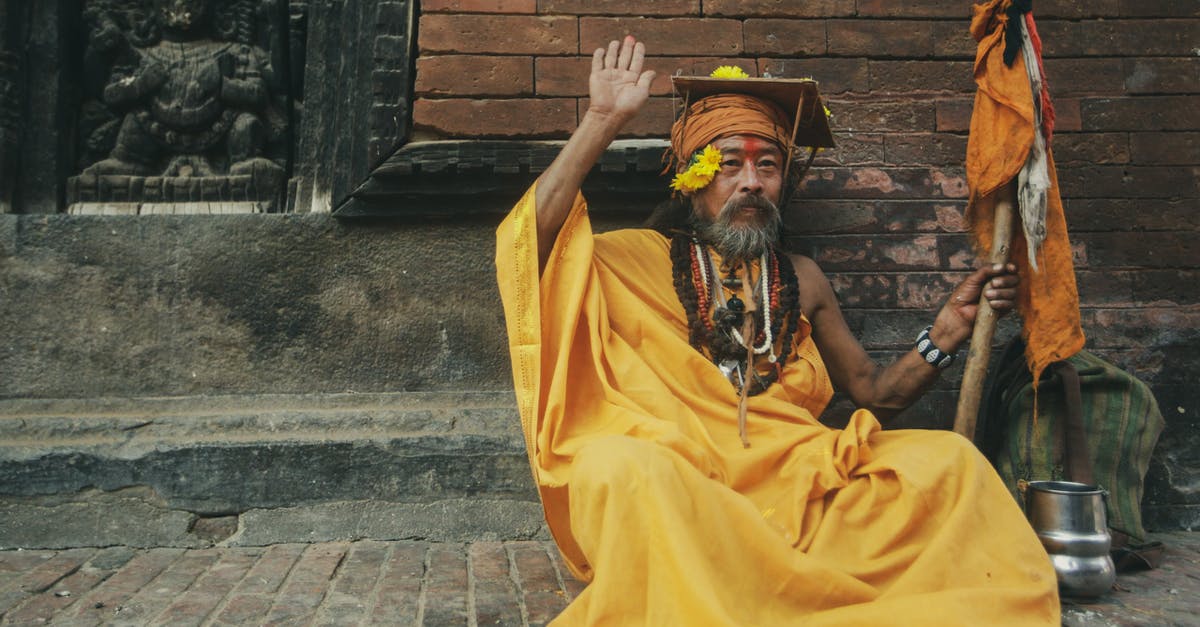 Are all stainless pans necessarily non stick? - A Man in Yellow Traditional Wear Sitting on Pavement