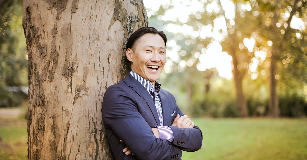 Are any kind of wood-chips good enough for smoking? - Photo of Man Leaning On Tree Trunk