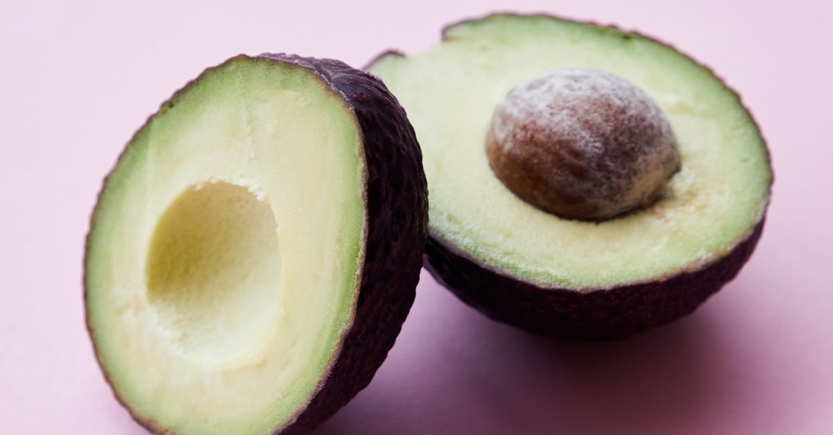 Are avocado seeds edible? - Halves of unpeeled avocado in studio