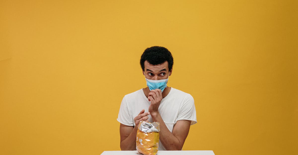 Are bunya-bunya nuts safe to eat if the shells are moldy? - Man in White Crew Neck T-shirt Eating Chips