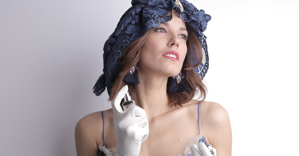 Are canned, unsweetened elderberries supposed to smell like blue cheese? - Charismatic sensual female in elegant vintage blue dress and lace headgear wearing white satin gloves and luxury bijouterie looking away and spraying fragrant perfume to delicate neck skin against white background