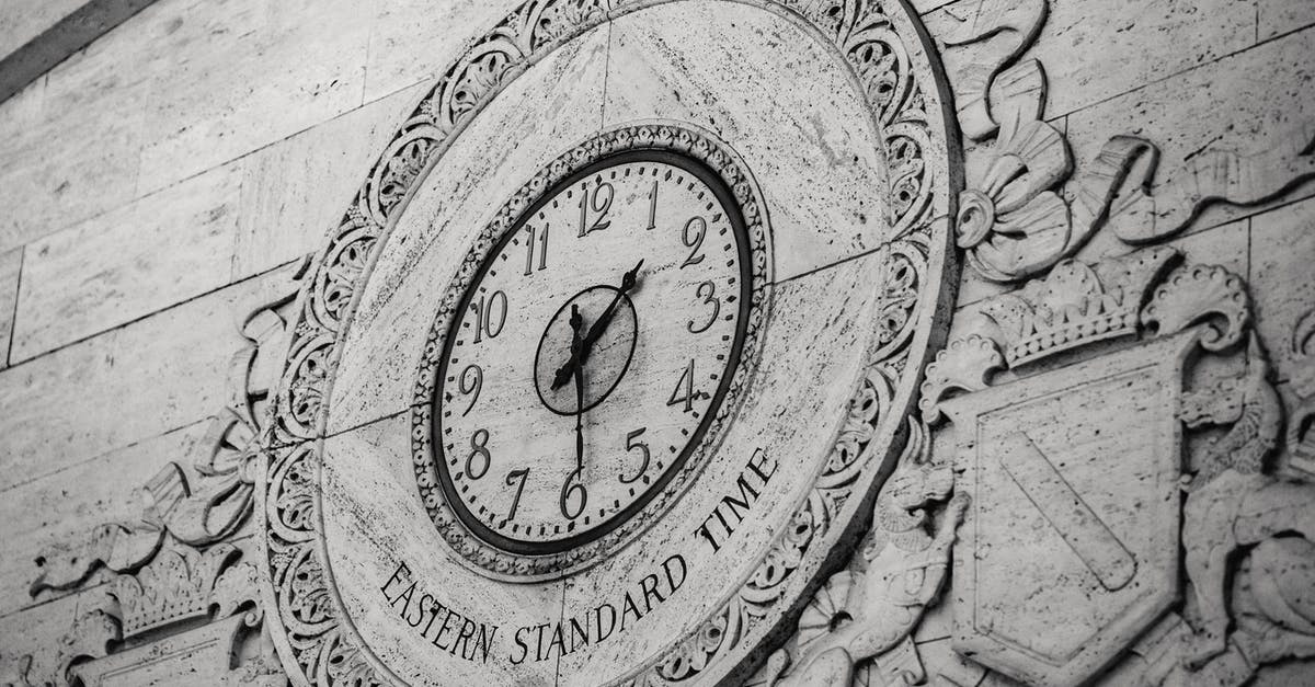 Are cooking show minutes really minutes? - From below black and white of stone wall with ornamental details around clock showing Eastern Standard Time