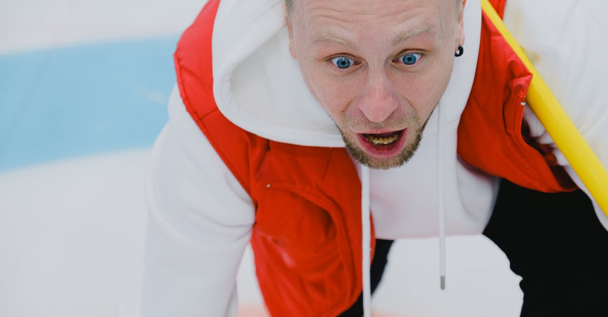 Are frozen mussels/clams supposed to be slightly open? - From above of thrilled male curler with broom watching stone sliding on ice sheet during curling competition