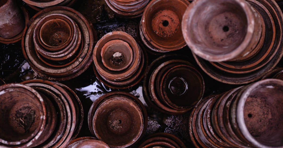 Are heavy-bottom stock pots called something else? - Top View Photo of Pile of Brown Round Clay Pots