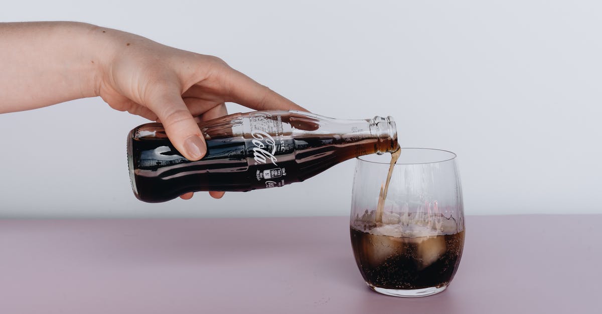 Are ice tea in bottles considered as carbonated drinks like coke? - Photo Of Person Pouring Soft Drinks On Glass