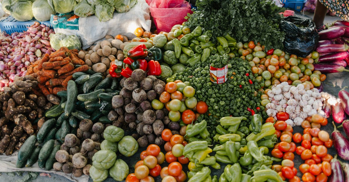 Are potato fruits (not "potatoes") edible? - From above of various vegetables including pepper beets cabbage tomatoes greens potato zucchini and carrot at bazaar