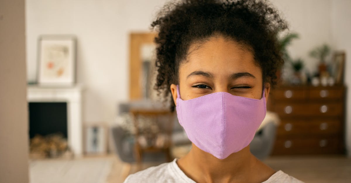 Are purple spots in freezer safe? - Cheerful African American teenage girl wearing protective mask winking and looking at camera on blurred background during coronavirus pandemic at home