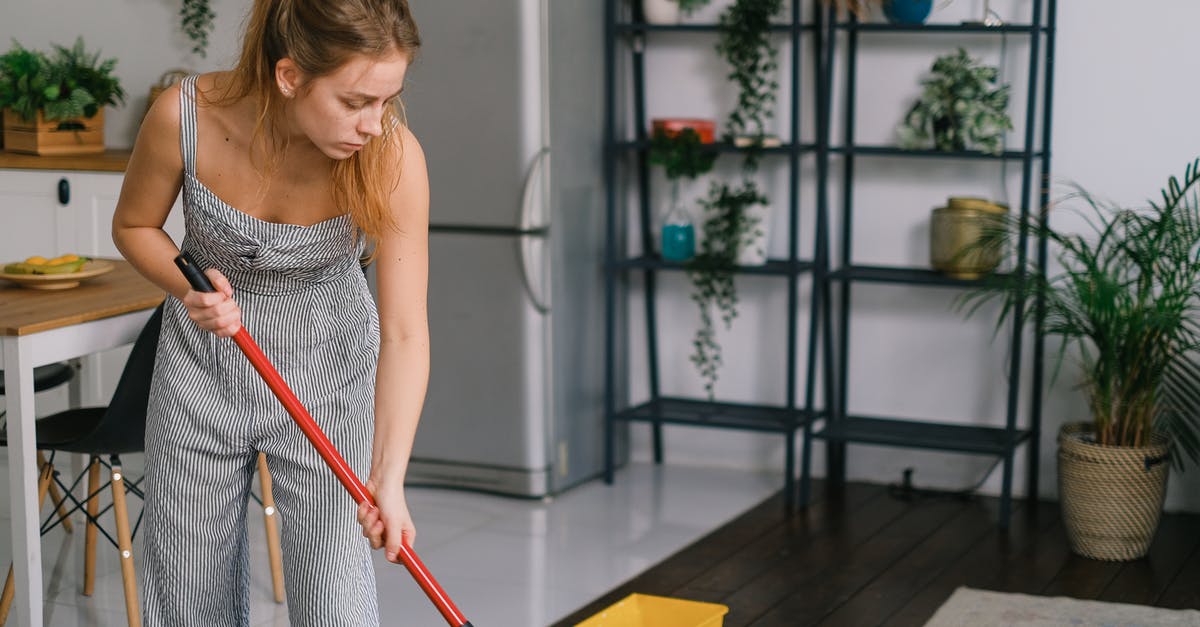 Are screwed on pot handles an indication of quality? - Housewife cleaning wooden floor in light room