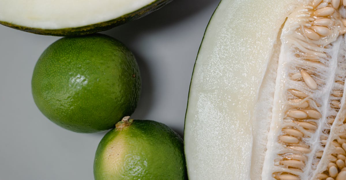 Are seeds in melons and other fruits good to eat? - Close-up Shot of Green Limes and a Cantaloupe Cut in Half