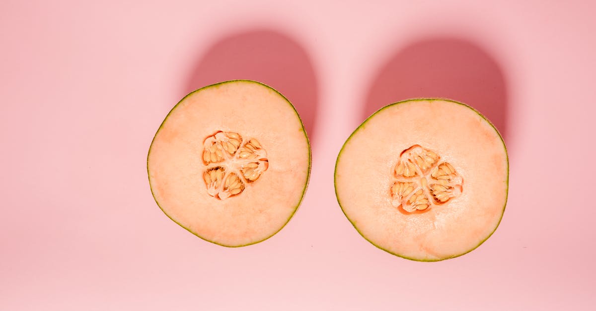 Are sharkfin melon shoots really edible? - Top view of ripe orange melon cut into halves for healthy diet placed on pink background in modern light studio